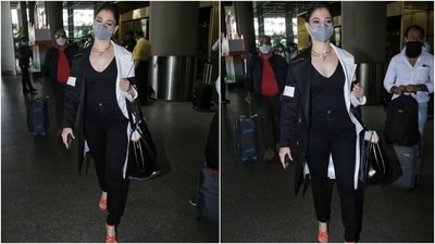 Tamannaah carried a black and white tote bag with her jet-set ensemble. A grey face mask, to protect herself amid the pandemic, rounded off her chic ensemble. (HT Photo/Varinder Chawla)