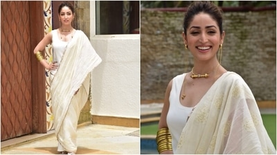 Yami teamed the modern look with vintage gold jewellery. She chose a gold necklace with matching stacked bangles. However, the highlight of her look was the statement-making dangling earrings that featured chain detail. (HT Photo/Varinder Chawla)