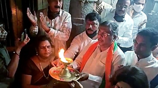 Maharashtra BJP chief Chandrakant Patil along with party supporters performs a ritual at a temple in Pune on Monday, during a protest demanding the reopening of religious places. (ANI)