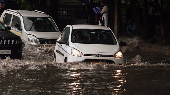 Vehicles move through a wheel-deep waterlogged road during heavy rainfall in Delhi on September 1. (ANI)