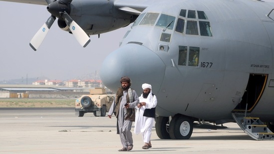 Taliban walk in front of a military airplane a day after the U.S. troops withdrawal from Hamid Karzai International Airport in Kabul, Afghanistan.(Reuters)