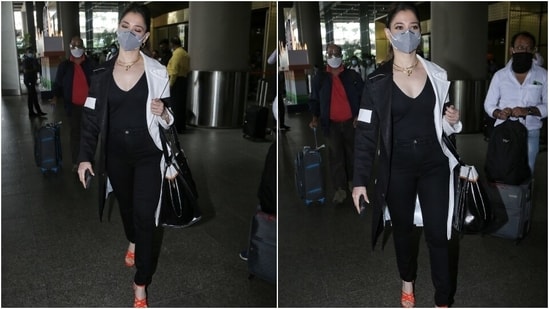 Tamannaah carried a black and white tote bag with her jet-set ensemble. A grey face mask, to protect herself amid the pandemic, rounded off her chic ensemble.(HT Photo/Varinder Chawla)