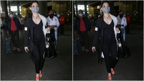 Tamannaah chose an all-black look for her arrival in the bay. She wore a black plunging neckline top and teamed it with straight-fit black denim pants.(HT Photo/Varinder Chawla)