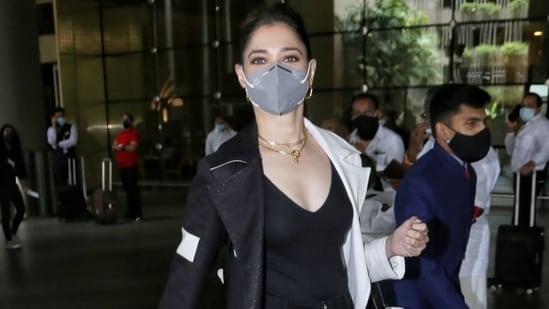 Airport fashion is all about mixing comfort and style, and no one understands this better than Indian actor Tamannaah Bhatia. The star was snapped at the airport today and looked chic in her trendy outfit.(HT Photo/Varinder Chawla)