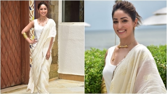 Yami tied her locks in a messy bun and chose peep-toe white sandals to complete her look. For glam, she opted for sleek eyeliner, blushed cheeks, nude pink lip shade, dewy skin and subtle eye shadow.(HT Photo/Varinder Chawla)