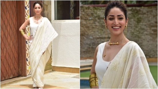 Yami teamed the modern look with vintage gold jewellery. She chose a gold necklace with matching stacked bangles. However, the highlight of her look was the statement-making dangling earrings that featured chain detail.(HT Photo/Varinder Chawla)