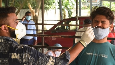 Healthcare workers take sample for Covid-19 testing of a person (HT File) Healthcare workers take sample for Covid-19 testing of a person (HT File)