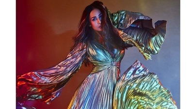 Malaika looked absolutely gorgeous with her long, coloured hair in loose waves as she posed with her dazzling dress, making it swish around and letting it's vibrant palette dance in the light. (Instagram)
