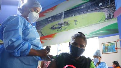 A healthcare worker inoculates a beneficiary against Covid-19 during a vaccination camp at Shahaji Raje Sports Complex, Andheri (West), in Mumbai on Wednesday. (Vijay Bate/HT photo)