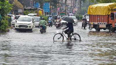 Commuters wade through a waterlogged Ashok Vihar area after heavy rain in New Delhi on Wednesday. (PTI) Commuters wade through a waterlogged Ashok Vihar area after heavy rain in New Delhi on Wednesday. (PTI)