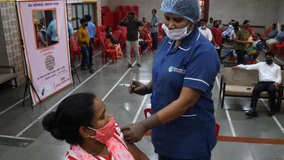 A health worker inoculates a beneficiary against Covid-19 during a free vaccination camp organised by Parth Foundation at Mahim, in Mumbai on Thursday. (Bhushan Koyande/ HT) A health worker inoculates a beneficiary against Covid-19 during a free vaccination camp organised by Parth Foundation at Mahim, in Mumbai on Thursday. (Bhushan Koyande/ HT)