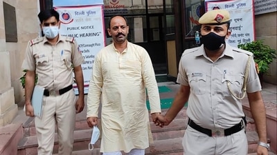 Delhi Police personnel with Hindu Raksha Dal leader Pinki Chaudhary, arrested in connection with communal sloganeering at Jantar Mantar during a protest, in New Delhi. (PTI Photo) Delhi Police personnel with Hindu Raksha Dal leader Pinki Chaudhary, arrested in connection with communal sloganeering at Jantar Mantar during a protest, in New Delhi. (PTI Photo)