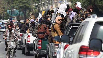A man on his bicycle rides past a convoy of Taliban fighters patrolling along a street in Kabul on September 2. (AFP) A man on his bicycle rides past a convoy of Taliban fighters patrolling along a street in Kabul on September 2. (AFP)