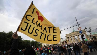 Climate activists during a protest at the Brandenburg Gate in Berlin, Germany. (Bloomberg) Climate activists during a protest at the Brandenburg Gate in Berlin, Germany. (Bloomberg)