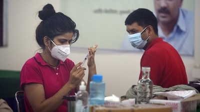 A healthcare worker prepares a dose of Covid-19 vaccine, at a government school in New Delhi on Thursday. (Raj K Raj/HT Photo)
