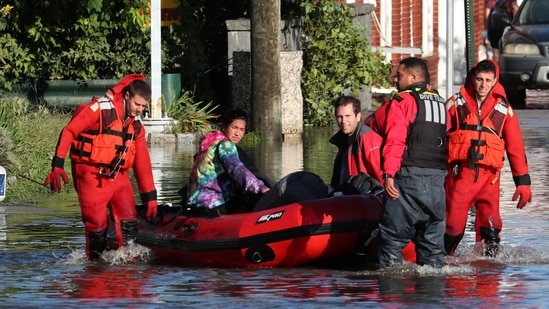 First responders pull local residents in a boat as they perform rescues of people trapped by floodwaters after the remnants of Tropical Storm Ida brought drenching rain, flash floods and tornadoes to parts of the northeast in Mamaroneck, New York, US(Reuters)