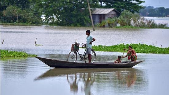 People move in a boat through a flooded field in Marigaon district in Assam on Thursday. (REUTERS PHOTO.) People move in a boat through a flooded field in Marigaon district in Assam on Thursday. (REUTERS PHOTO.)