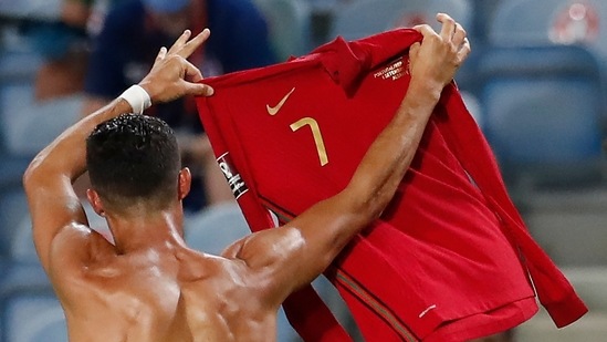Portugal's Cristiano Ronaldo holds up his shirt as he celebrates after scoring his side's second goal during the World Cup 2022 group A qualifying match.(AP)
