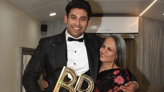 Sidharth Shukla poses with his mother, holding his Bigg Boss trophy.