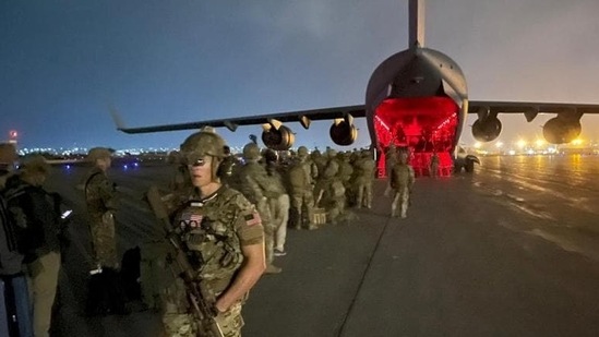 Paratroopers assigned to the 82nd Airborne Division board a US Air Force C-17 to leave Hamid Karzai International Airport in Kabul, Afghanistan on Monday. (REUTERS)