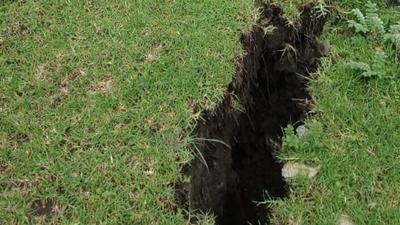 Wide cracks surfaced in the ground in Sainrathi village of Pithoragarh. (HT photo)