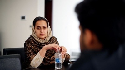 Afghan news anchor Beheshta Arghand speaks to her brother at a temporary residence compound in Doha, Qatar, on September 1, 2021. (Hamad I Mohammed / REUTERS)