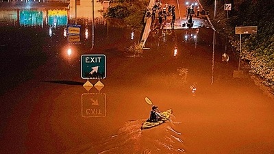 A kayaker paddles down a portion of a highway after flooding in Philadelphia, Pennsylvania. (AFP) A kayaker paddles down a portion of a highway after flooding in Philadelphia, Pennsylvania. (AFP)