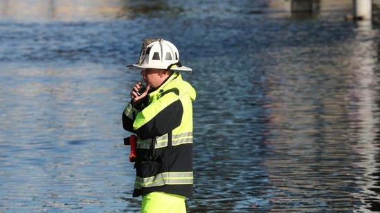 A first responder stands by floodwaters after the remnants of Tropical Storm Ida brought drenching rain, flash floods and tornadoes to parts of the northeast in Mamaroneck, New York, (REUTERS)