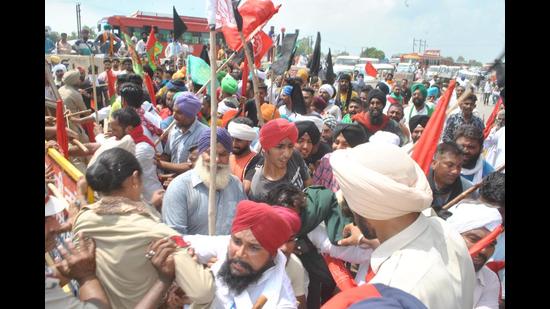 Protesters trying to break through police cordon to reach the rally venue of Shiromani Akali Dal in Moga on Thursday.