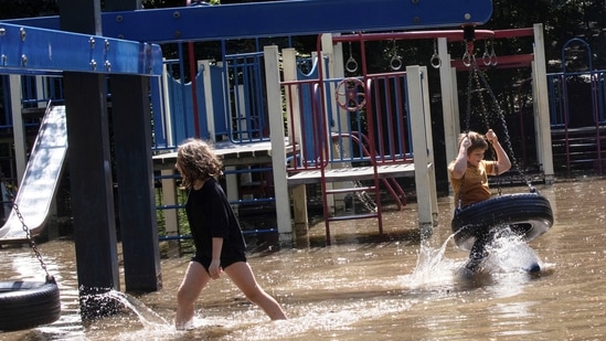 Children play at a flooded playground after the remnants of Tropical Storm Ida brought drenching rain and the threat of flash floods and tornadoes to parts of the northern mid-Atlantic, in the Brooklyn borough of New York City, U.S.(REUTERS)