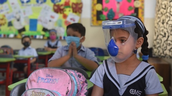 A primary school girl from Uttar Pradesh wears a full face face gear to protect herself from Covid-19. (HT Photo/Deepak Gupta)