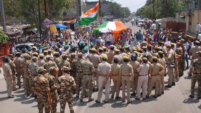 Farmers stage a protest as security personnel look on, in Noida on September 3. (PTI) Farmers stage a protest as security personnel look on, in Noida on September 3. (PTI)