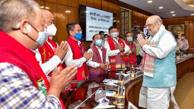 Union Home Minister Amit Shah greets members from different groups of Assam after signing the Karbi Anglong Peace agreement at the Home Ministry in New Delhi on Saturday. (PTI PHOTO.)