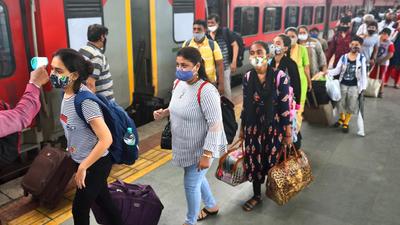 BMC health worker checks temperatures of passengers arriving from outstation trains at Dadar station. (Satish Bate/HT PHOTO) BMC health worker checks temperatures of passengers arriving from outstation trains at Dadar station. (Satish Bate/HT PHOTO)