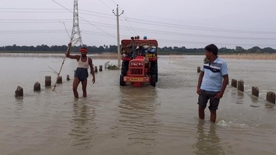 People wade through a flooded area due to heavy rains in Begusarai, Bihar. (ANI) People wade through a flooded area due to heavy rains in Begusarai, Bihar. (ANI)