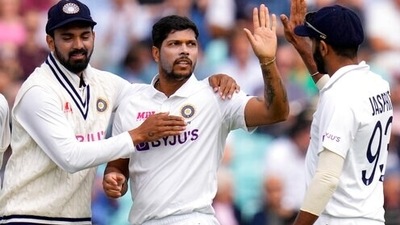 India's Umesh Yadav, centre, celebrates taking the wicket of England's Craig Overton. (AP)