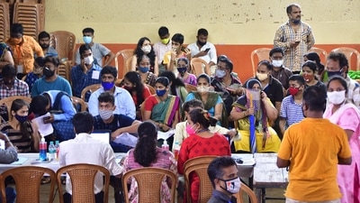 Beneficiaries wait to receive a dose of Covid-19 vaccine in Mumbai on Friday. (PTI Photo) Beneficiaries wait to receive a dose of Covid-19 vaccine in Mumbai on Friday. (PTI Photo)