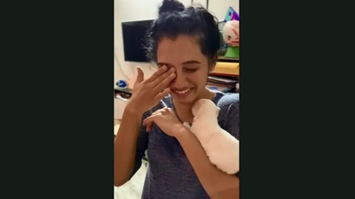 The image shows the woman holding the puppy. (Jukin Media)