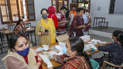 A medic administers a dose of Covid-19 vaccine to a beneficiary at a vaccination centre in Jammu. (PTI) A medic administers a dose of Covid-19 vaccine to a beneficiary at a vaccination centre in Jammu. (PTI)