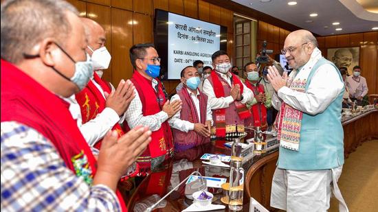 Union Home Minister Amit Shah greets members from different groups of Assam after signing the Karbi Anglong Peace agreement at the Home Ministry in New Delhi on Saturday. (PTI PHOTO.)