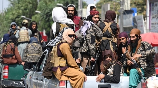 Taliban fighters patrol on vehicles along a street in Kabul.&nbsp;(AFP Photo)