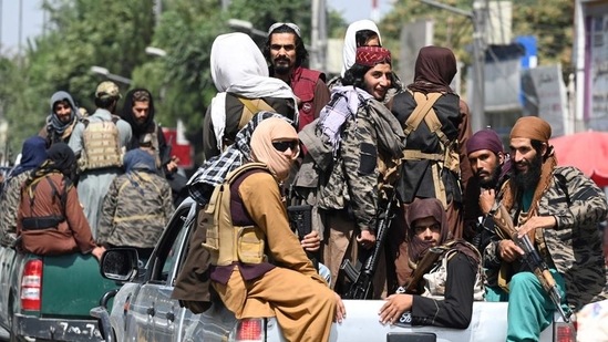 Taliban fighters patrol on vehicles along a street in Kabul. (AFP Photo)