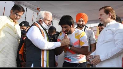 Haryana chief minister Manohar Lal Khattar honouring Tokyo Olympics 2020 bronze medallist wrestler Bajrang Punia at the latter’s Khudan village in Haryana on Sunday. MP Arvind Sharma and BJP state president OP Dhankhar and state sports minister Sandeep Singh are also seen in the picture. (HT PHOTO)