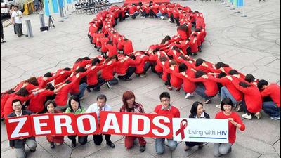 Dozens of volunteers join a human chain in the form of a red ribbon, a symbol of "love and care" for HIV and AIDS carriers worldwide, at a gathering in downtown Taipei ahead of World AIDS Day. The theme of the 2011 global campaign to fight AIDS is 'Getting to Zero'. Dozens of volunteers join a human chain in the form of a red ribbon, a symbol of "love and care" for HIV and AIDS carriers worldwide, at a gathering in downtown Taipei ahead of World AIDS Day. The theme of the 2011 global campaign to fight AIDS is 'Getting to Zero'.