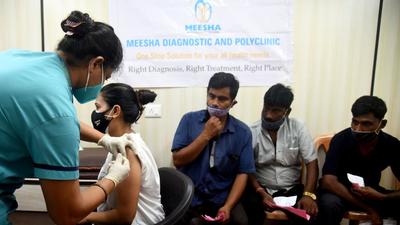 A citizen gets a dose of Covid vaccine during a special vaccination camp for porters and shoe polishers at Borivali in Mumbai on Sunday. (Vijay Bate/HT)