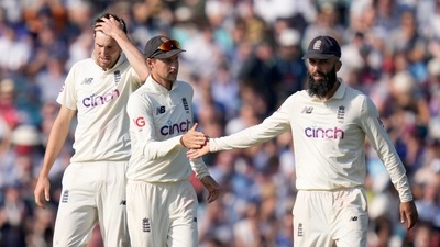 England's Joe Root shakes hands with England's Moeen Ali after he catches India's Umesh Yadav to get India all out for 466 on day four of the fourth Test match at The Oval cricket ground in London, Sunday, Sept. 5, 2021. (AP Photo/Kirsty Wigglesworth) (AP) England's Joe Root shakes hands with England's Moeen Ali after he catches India's Umesh Yadav to get India all out for 466 on day four of the fourth Test match at The Oval cricket ground in London, Sunday, Sept. 5, 2021. (AP Photo/Kirsty Wigglesworth) (AP)