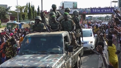 Residents cheer at army soldiers as they celebrate the uprising in Conakry, Guinea. (Reuters)