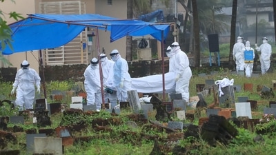 Health workers bury the body of a 12-year-old Nipah virus victim, at Kannamparambu cemetery in Kozhikode (PTI Photo) Health workers bury the body of a 12-year-old Nipah virus victim, at Kannamparambu cemetery in Kozhikode (PTI Photo)