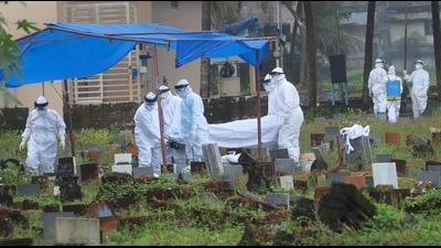 Health workers bury the body of a 12-year-old Nipah virus victim, at Kannamparambu cemetery in Kozhikode, Sunday. (PTI) Health workers bury the body of a 12-year-old Nipah virus victim, at Kannamparambu cemetery in Kozhikode, Sunday. (PTI)