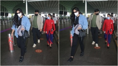 Karan Boolani complemented Rhea in a green T-shirt, navy pants and a grey jacket. The filmmaker and producer teamed the airport look with white sneakers and a black face mask. (HT Photo/Varinder Chawla)